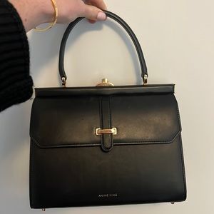 Pre loved black Queen Elizabeth bag. Click lock, two compartments, inner zipper.